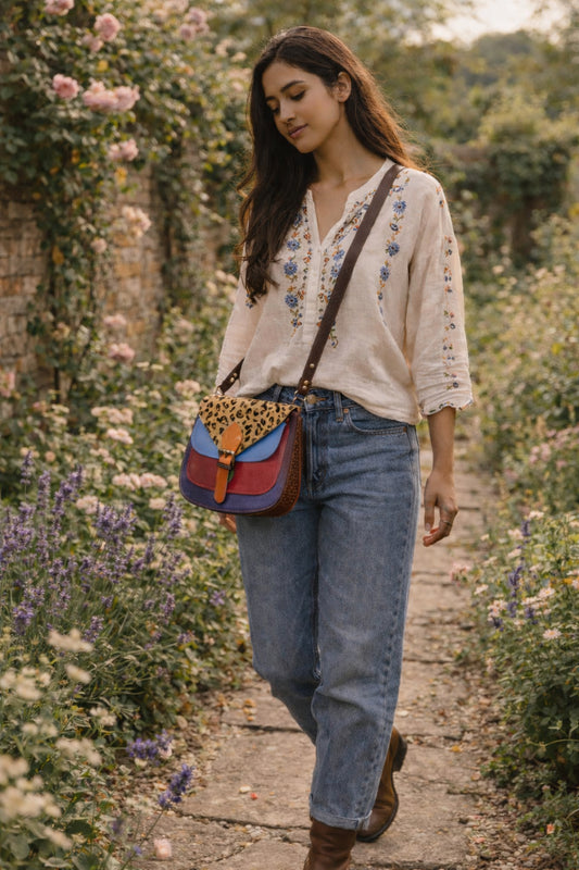 Handmade Leather Crossbody Bag - Romy in vibrant colors with leopard print flap, showcasing unique design and sustainability.
