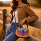 Handmade Leather Crossbody Bag featuring vibrant colors and a unique spotted design on the flap.