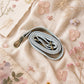 Handmade Leather Crossbody Bag - Romy - Painted Garden - Celeste on a soft background with dried flowers.