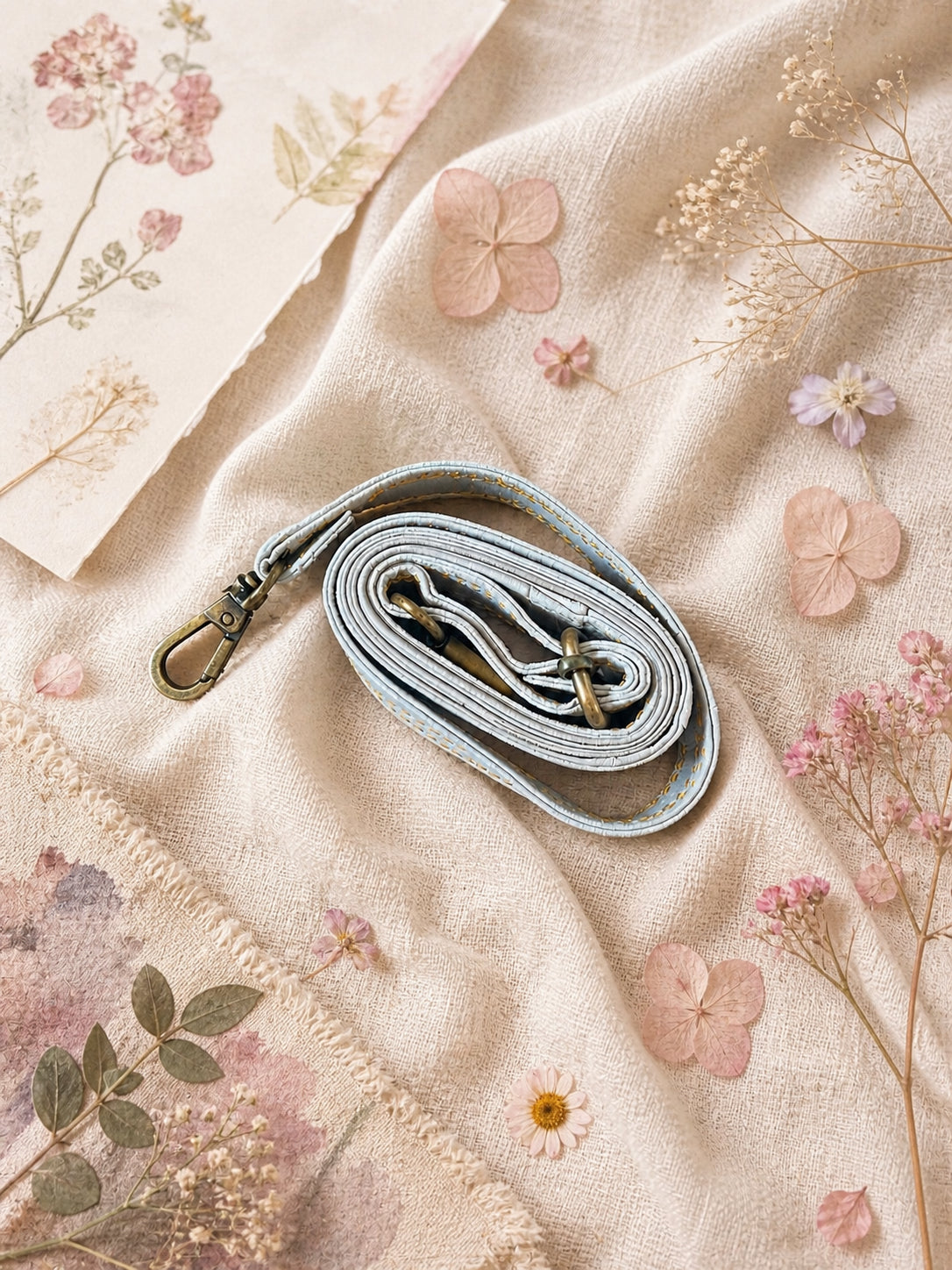 Handmade Leather Crossbody Bag - Romy - Painted Garden - Celeste on a soft background with dried flowers.