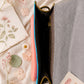 Handmade Leather Crossbody Bag - Romy - Painted Garden - Celeste on a soft background with dried flowers.