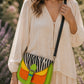 Handmade Leather Crossbody Bag with vibrant colors and zebra print flap on a floral background.