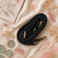 Handmade Leather Crossbody Bag with vibrant colors and zebra print flap on a floral background.
