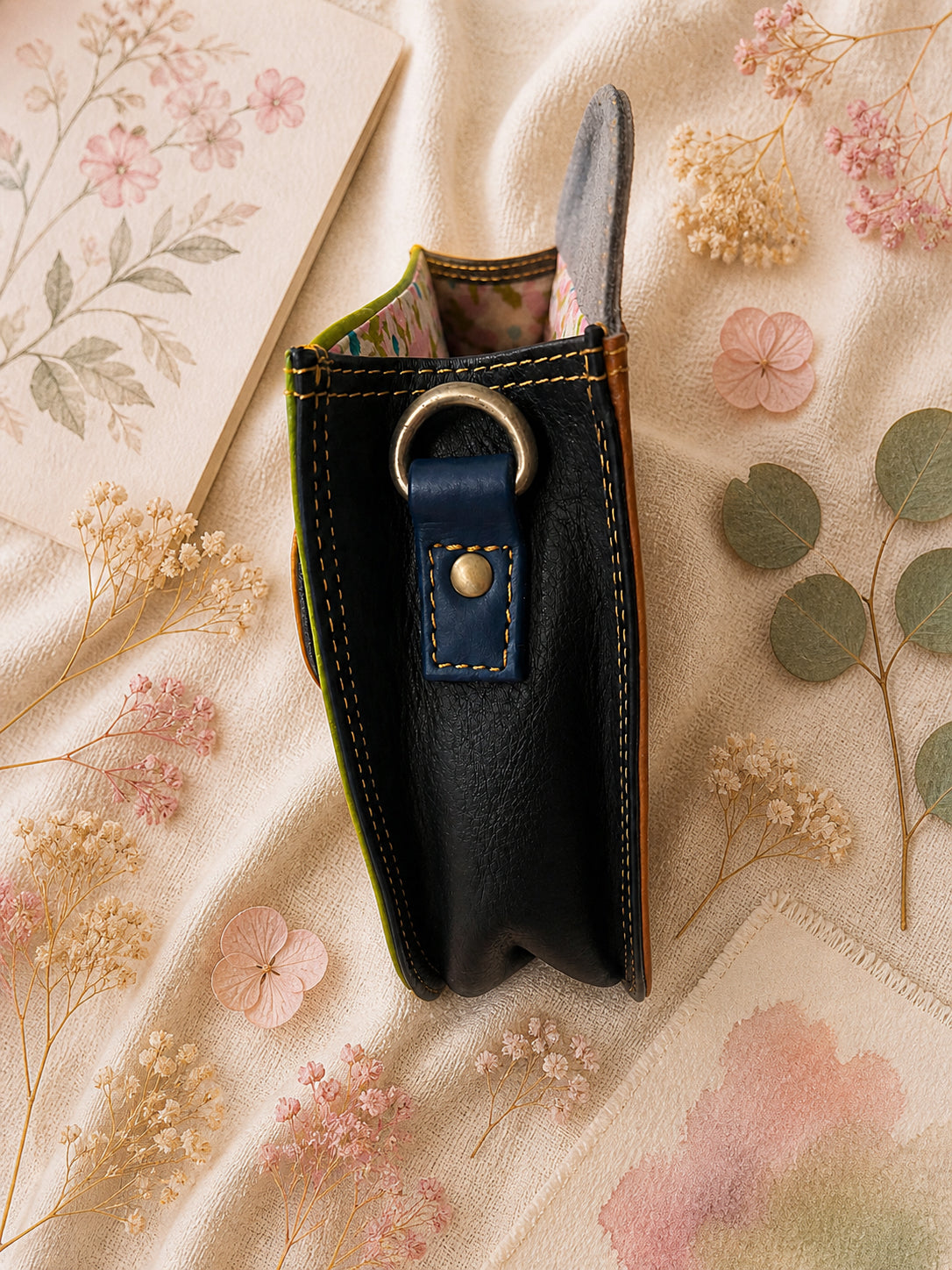Handmade Leather Crossbody Bag with vibrant colors and zebra print flap on a floral background.
