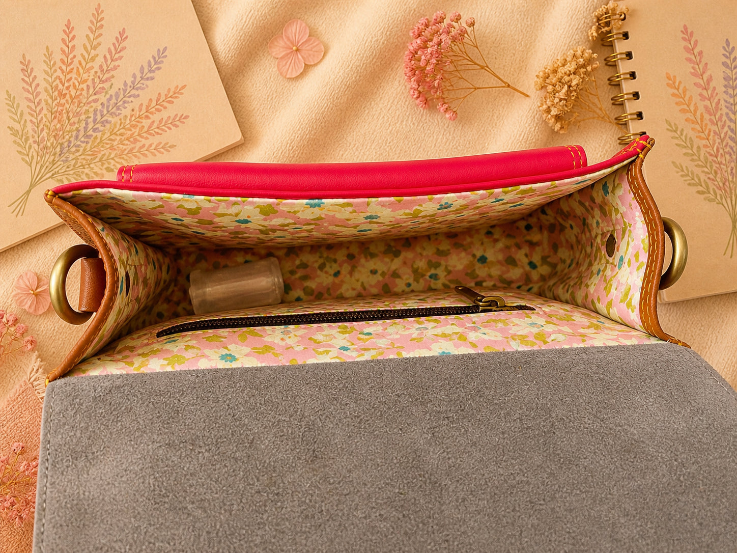 Handmade Leather Crossbody Bag in vibrant red and yellow with floral background.