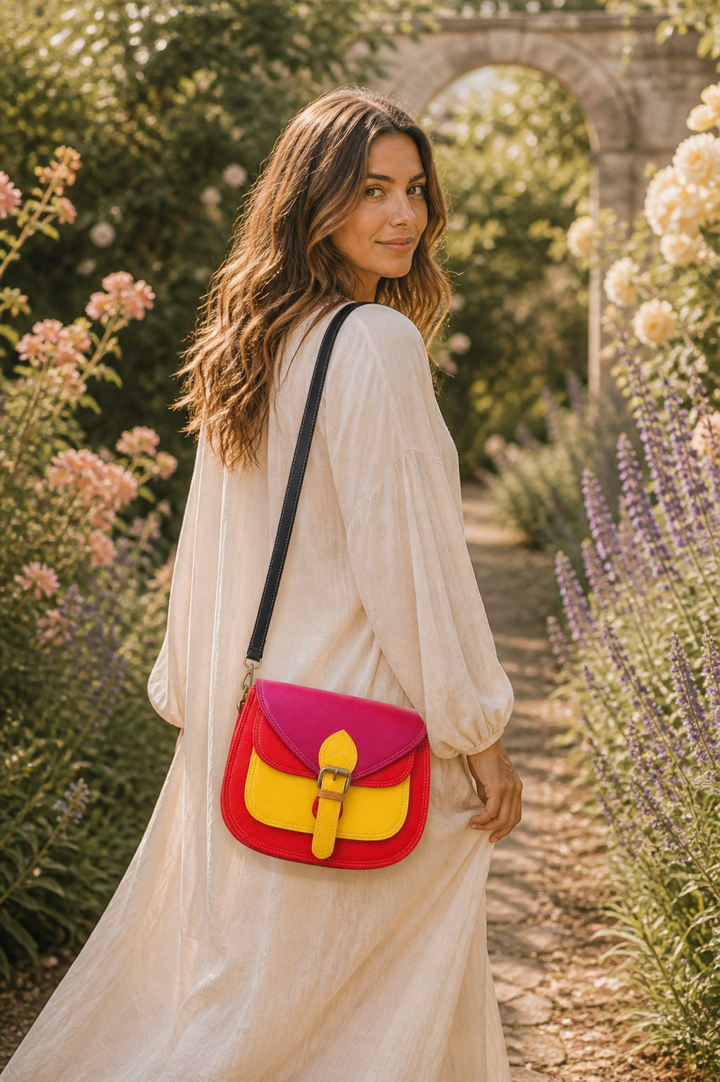 Handmade Leather Crossbody Bag in vibrant red and yellow with floral background.