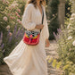 Handmade Leather Crossbody Bag featuring a vibrant painted design with pink, yellow, and animal print accents.