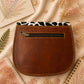 Handmade Leather Crossbody Bag featuring a vibrant painted design with pink, yellow, and animal print accents.