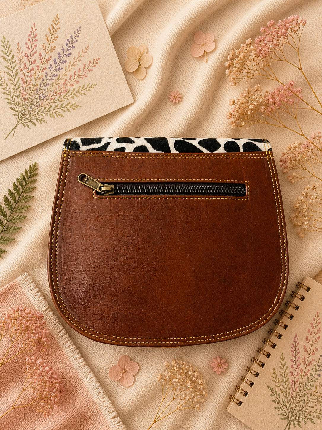 Handmade Leather Crossbody Bag featuring a vibrant painted design with pink, yellow, and animal print accents.