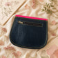 Handmade Leather Crossbody Bag in vibrant fuchsia, blue, and red colors, featuring a stylish buckle detail on a floral background.