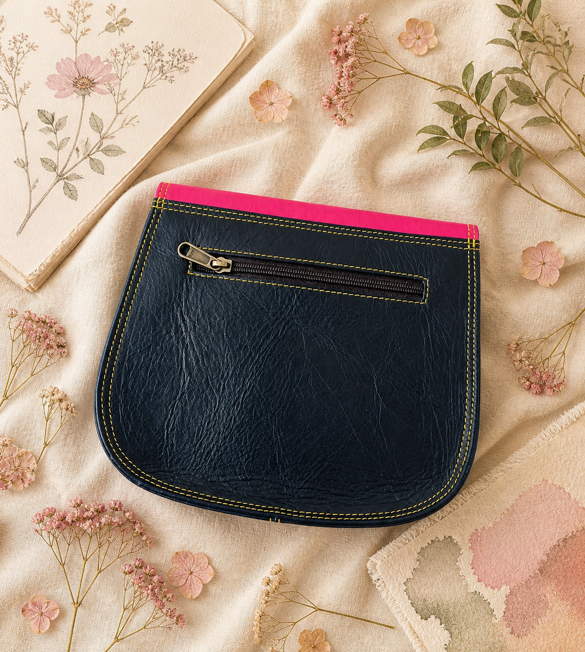 Handmade Leather Crossbody Bag in vibrant fuchsia, blue, and red colors, featuring a stylish buckle detail on a floral background.