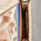 Handmade Leather Crossbody Bag in vibrant fuchsia, blue, and red colors, featuring a stylish buckle detail on a floral background.