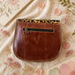 Handmade Leather Crossbody Bag featuring vibrant colors and leopard print flap design, perfect for stylish everyday use.