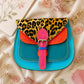 Handmade Leather Crossbody Bag featuring vibrant colors and leopard print flap design, perfect for stylish everyday use.