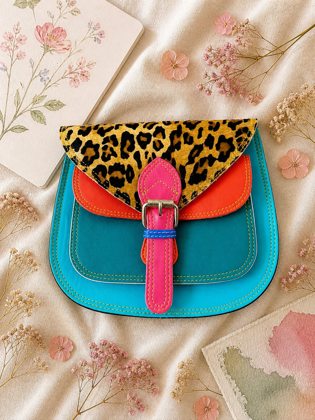 Handmade Leather Crossbody Bag featuring vibrant colors and leopard print flap design, perfect for stylish everyday use.