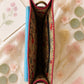 Handmade Leather Crossbody Bag featuring a colorful design with pink, blue, and patterned accents, showcasing unique craftsmanship.