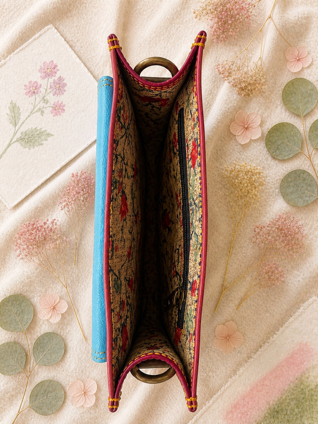 Handmade Leather Crossbody Bag featuring a colorful design with pink, blue, and patterned accents, showcasing unique craftsmanship.