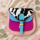 Handmade Leather Crossbody Bag featuring a colorful design with pink, blue, and patterned accents, showcasing unique craftsmanship.