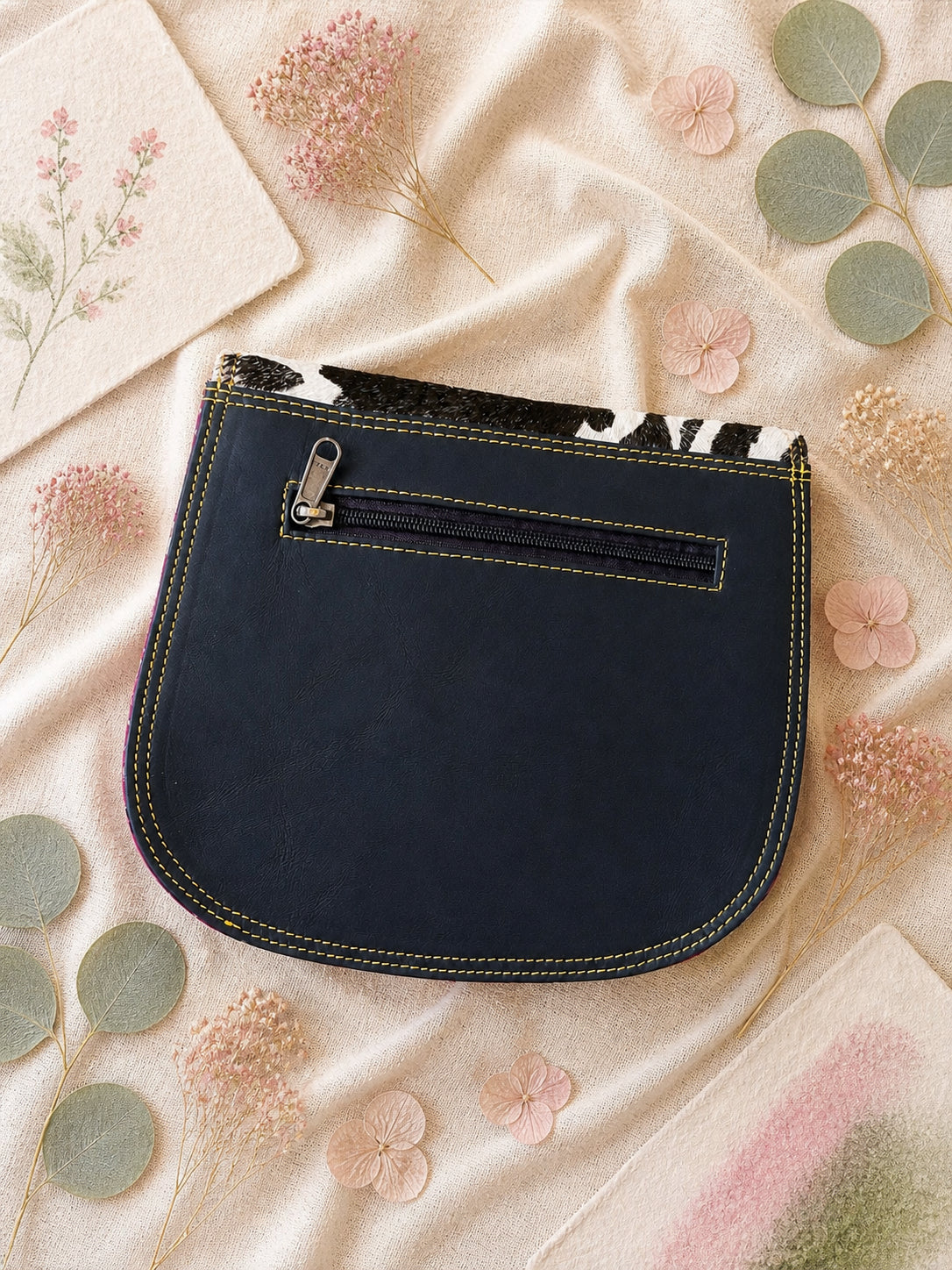 Handmade Leather Crossbody Bag featuring a colorful design with pink, blue, and patterned accents, showcasing unique craftsmanship.