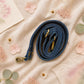 Handmade Leather Crossbody Bag featuring a colorful design with pink, blue, and patterned accents, showcasing unique craftsmanship.