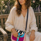 Handmade Leather Crossbody Bag featuring a colorful design with pink, blue, and patterned accents, showcasing unique craftsmanship.
