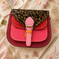 Handmade Leather Crossbody Bag featuring a vibrant pink and leopard print design, perfect for stylish everyday use.