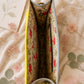 Handmade Leather Crossbody Bag - Romy - Painted Garden - Primrose in vibrant yellow and green leather with floral background.