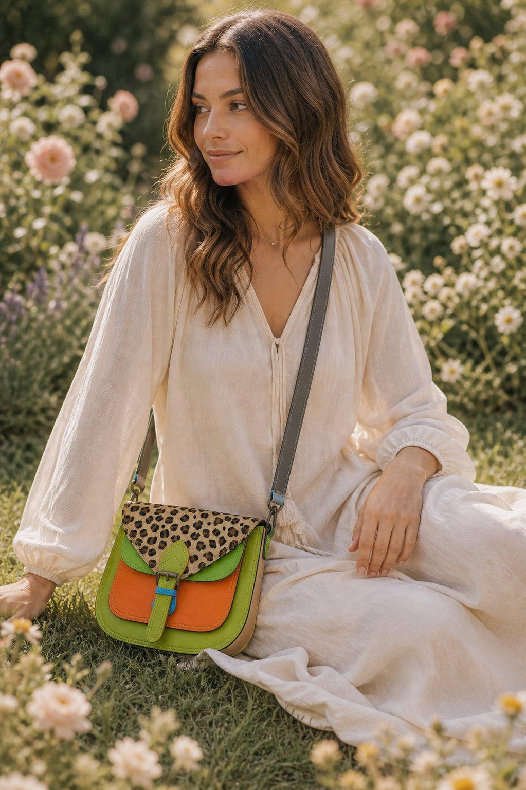 Handmade Leather Crossbody Bag in vibrant colors with leopard print flap on a textured background.