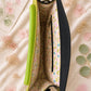 Handmade Leather Crossbody Bag in vibrant colors with leopard print flap on a textured background.