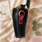 Handmade Leather Crossbody Bag in vibrant colors with leopard print flap on a textured background.