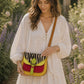 Handmade Leather Crossbody Bag - Romy with colorful zebra print and vibrant colors on a floral background.