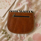 Handmade Leather Crossbody Bag - Romy with colorful zebra print and vibrant colors on a floral background.