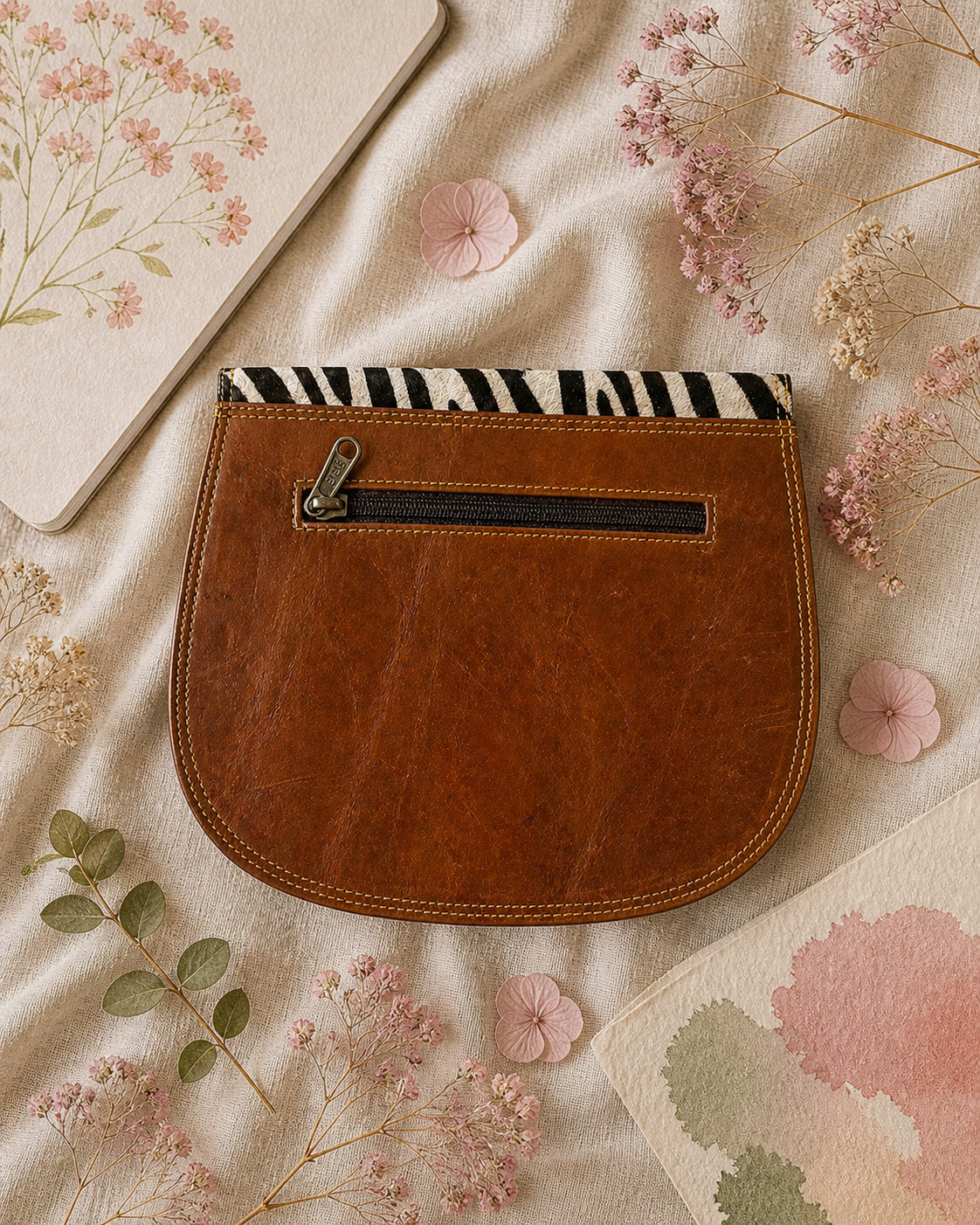 Handmade Leather Crossbody Bag - Romy with colorful zebra print and vibrant colors on a floral background.