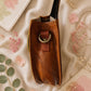 Handmade Leather Crossbody Bag - Romy with colorful zebra print and vibrant colors on a floral background.