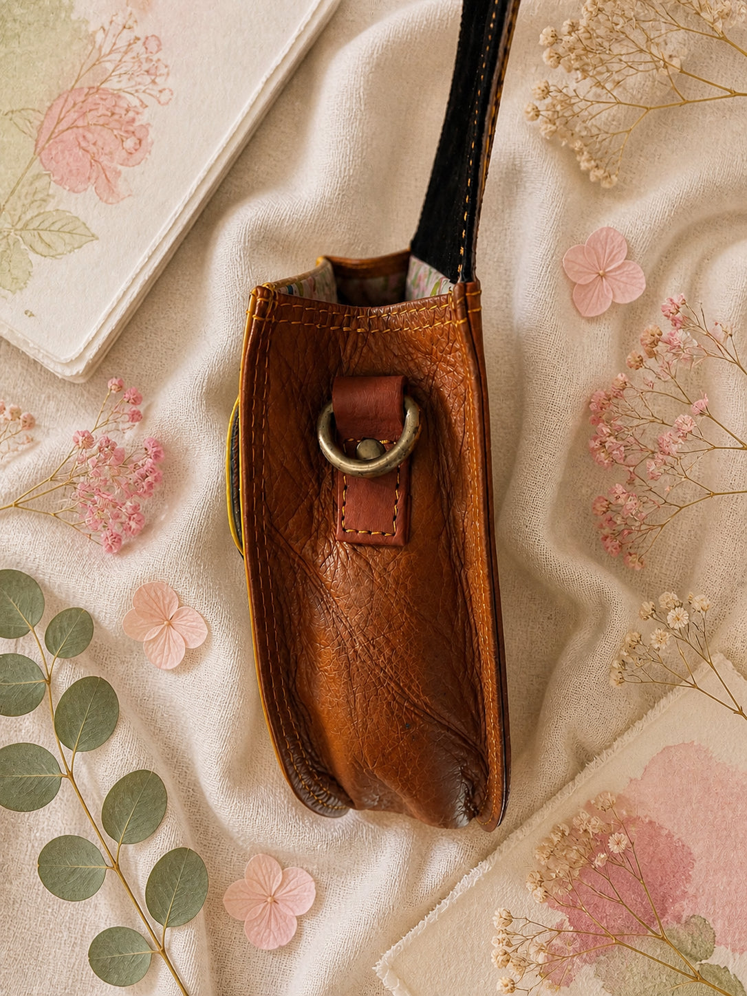 Handmade Leather Crossbody Bag - Romy with colorful zebra print and vibrant colors on a floral background.