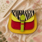 Handmade Leather Crossbody Bag - Romy with colorful zebra print and vibrant colors on a floral background.