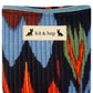Handmade cross body bag in vibrant colors worn by a woman in a field, showcasing style and comfort.