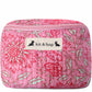 Handmade cross body bag Elara Wildflower Path in PINK FLORAL worn by woman in a field.