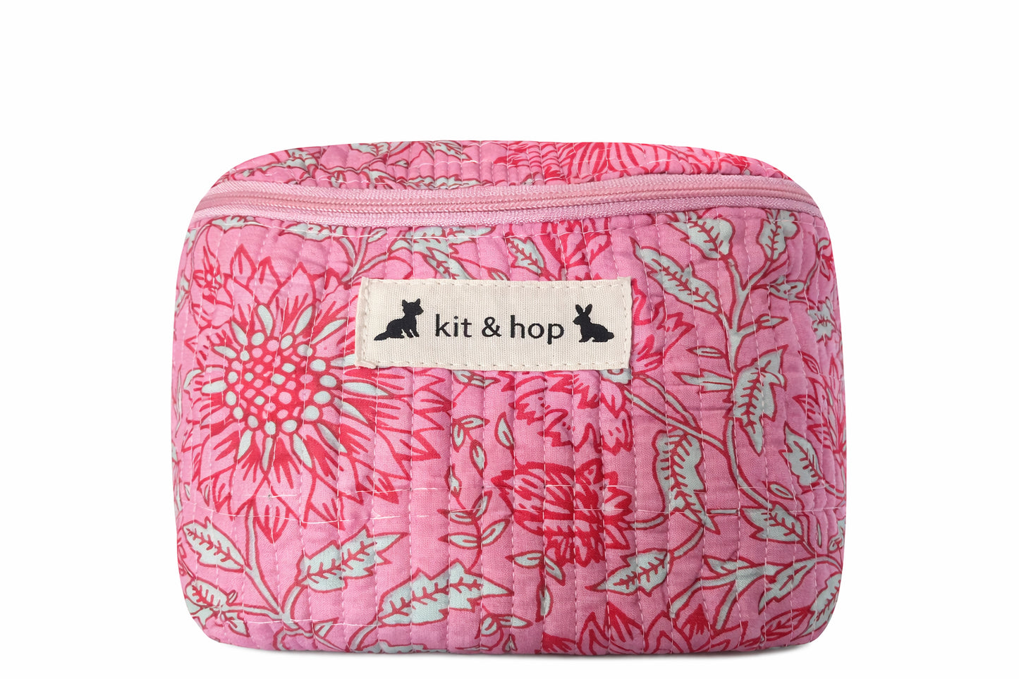 Handmade cross body bag Elara Wildflower Path in PINK FLORAL worn by woman in a field.