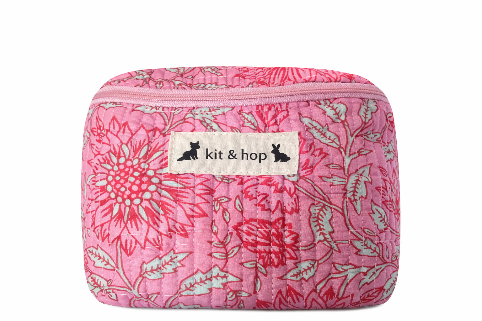 Handmade cross body bag Elara Wildflower Path in PINK FLORAL worn by woman in a field.