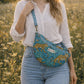 Handmade Cross Body Bag - Elara - Wildflower Path - Nyla worn by a model in a field during golden hour.