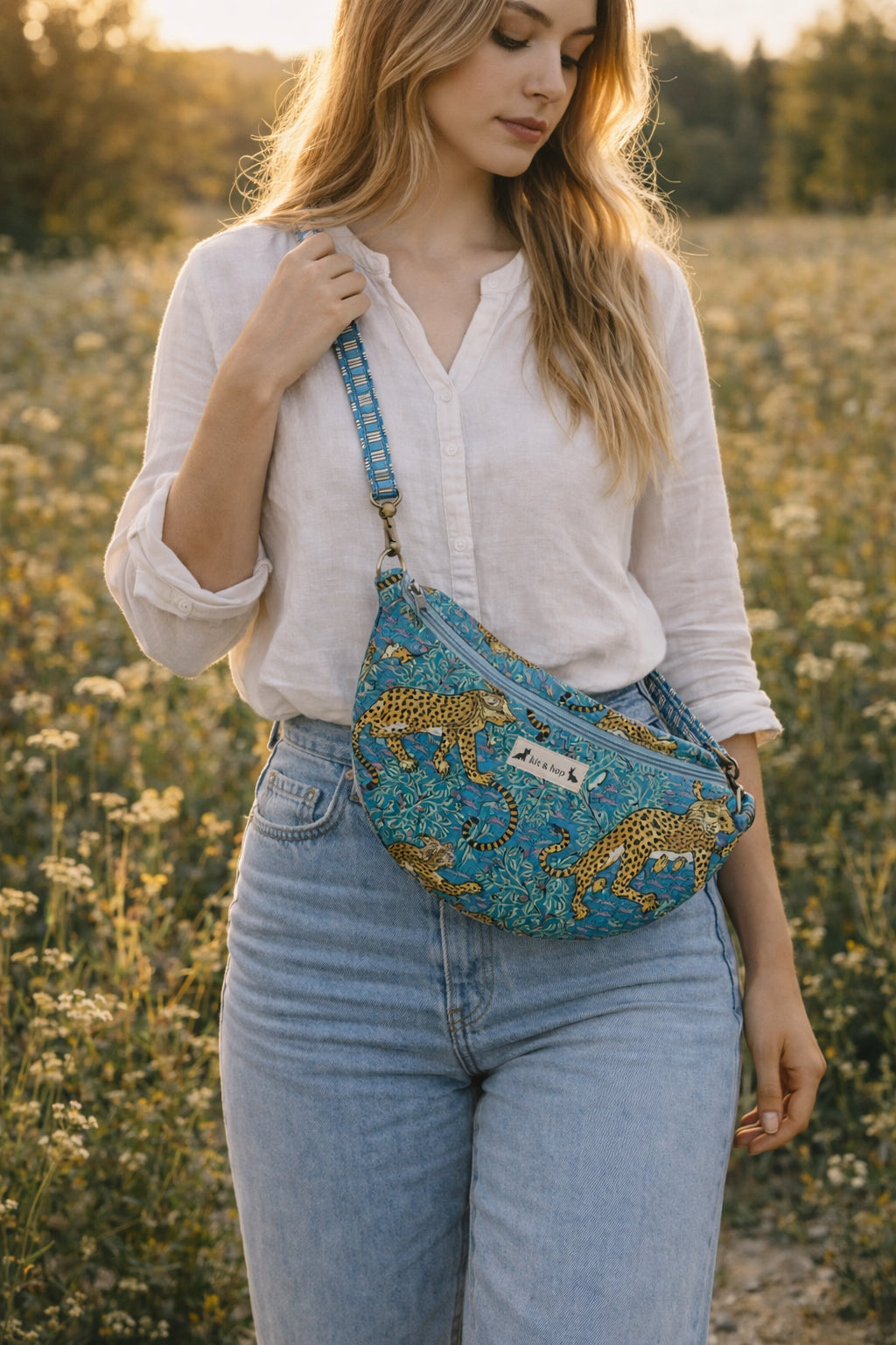 Handmade Cross Body Bag - Elara - Wildflower Path - Nyla worn by a model in a field during golden hour.