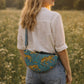 Handmade Cross Body Bag - Elara - Wildflower Path - Nyla worn by a model in a field during golden hour.