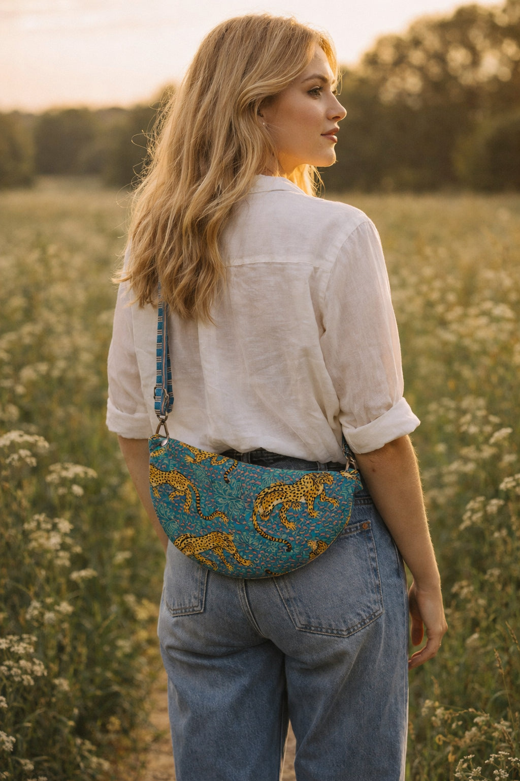 Handmade Cross Body Bag - Elara - Wildflower Path - Nyla worn by a model in a field during golden hour.