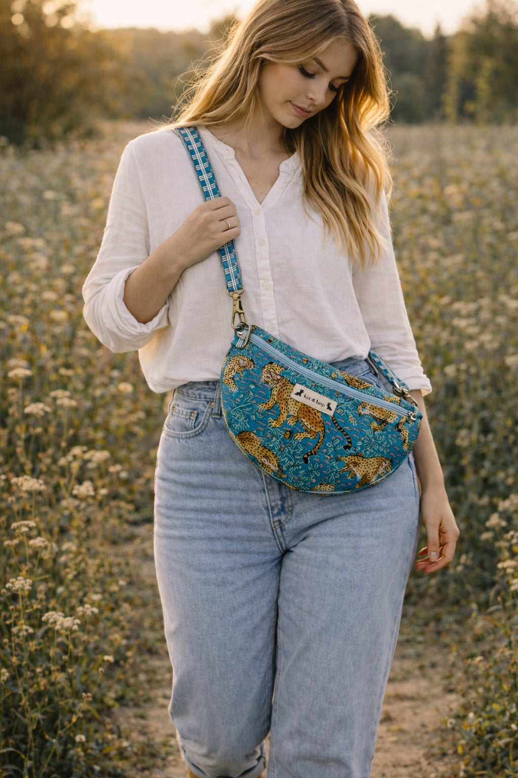 Handmade Cross Body Bag - Elara - Wildflower Path - Nyla worn by a model in a field during golden hour.