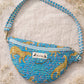 Handmade Cross Body Bag - Elara - Wildflower Path - Nyla worn by a model in a field during golden hour.