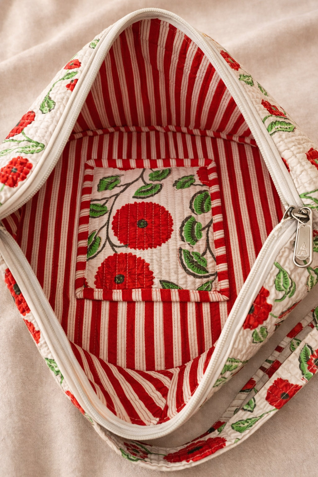 Handmade cross body bag Elara in Poppy pattern, worn by a woman in a field, perfect for everyday use.