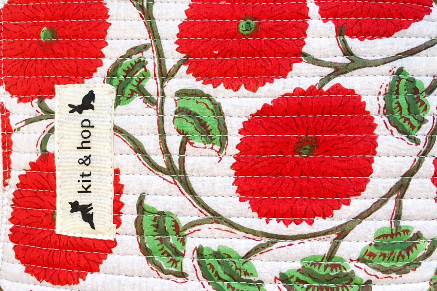 Handmade cross body bag Elara in Poppy pattern, worn by a woman in a field, perfect for everyday use.