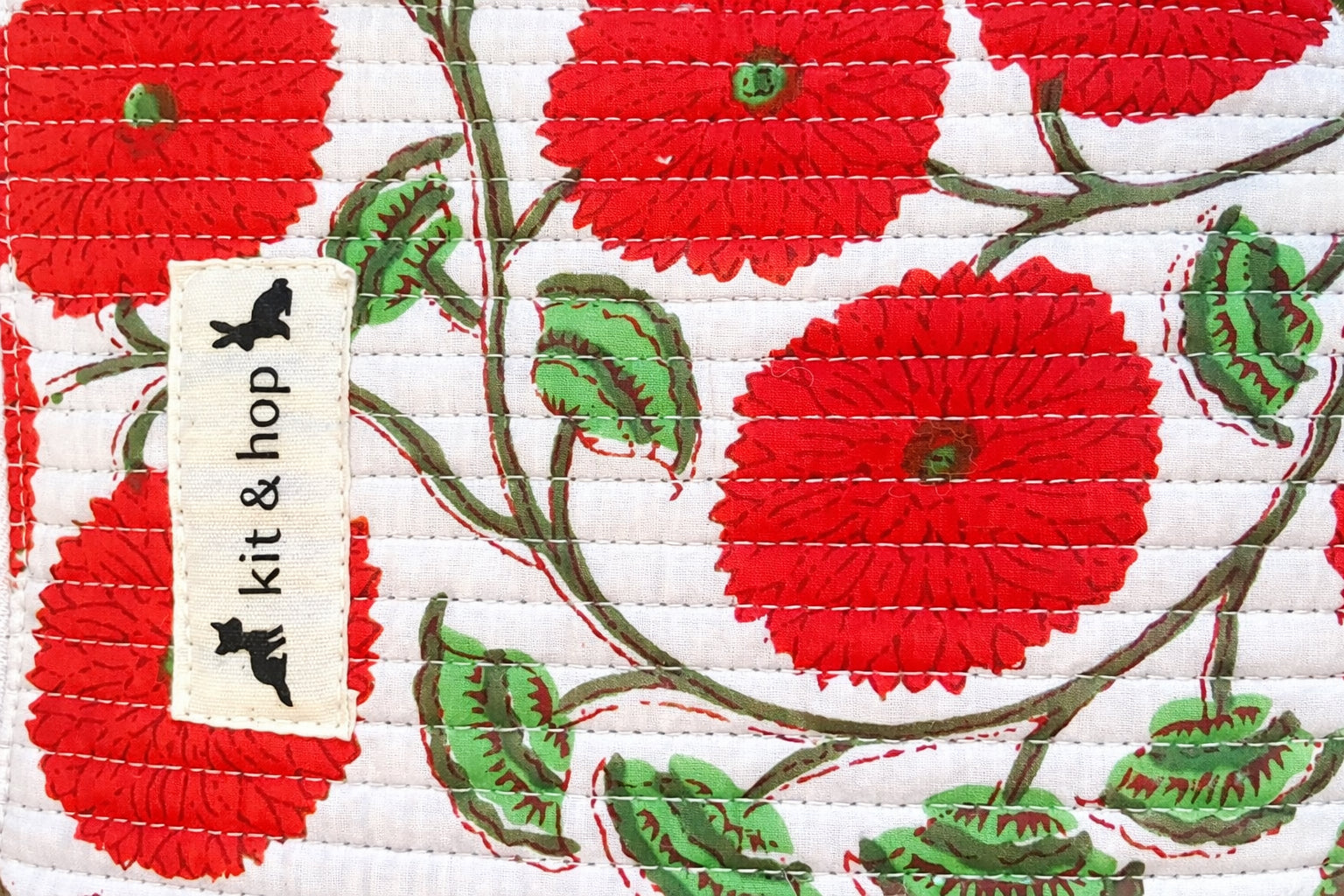Handmade cross body bag Elara in Poppy pattern, worn by a woman in a field, perfect for everyday use.