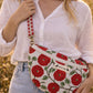 Handmade cross body bag Elara in Poppy pattern, worn by a woman in a field, perfect for everyday use.